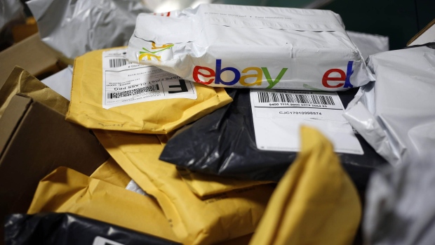 A parcel in eBay Inc. packaging is seen on a conveyor belt with other small parcels at the United States Postal Service. 