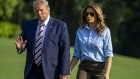 U.S. President Donald Trump waves while walking with First lady Melania Trump on the South Lawn of the White House after arriving on Marine One in Washington, D.C., U.S., on Sunday, Aug. 4, 2019. In his first verbal response to the two mass shootings over the weekend, which left about 30 people dead, Trump said that "hate has no place" in this country. Photographer: Tasos Katopodis/Bloomberg