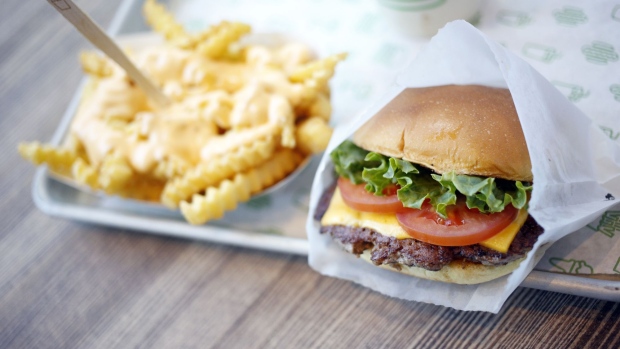 A ShackBurger, cheese fries, and milkshake are arranged for a photograph at a Shake Shack Inc. restaurant in Lexington, Kentucky, U.S., on Wednesday, March 6, 2019. Shake Shack is still failing to bring in more diners as it expands outside its home market of New York in the fiercely competitive restaurant space -- the chain plans to open 36 to 40 company-owned U.S. locations in fiscal 2019. 