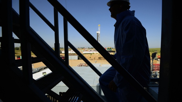 The silhouette of a contractor is seen walking up stairs at an Anadarko Petroleum Corp. oil rig site in Fort Lupton, Colorado, U.S., on Tuesday, Aug. 12, 2014. 