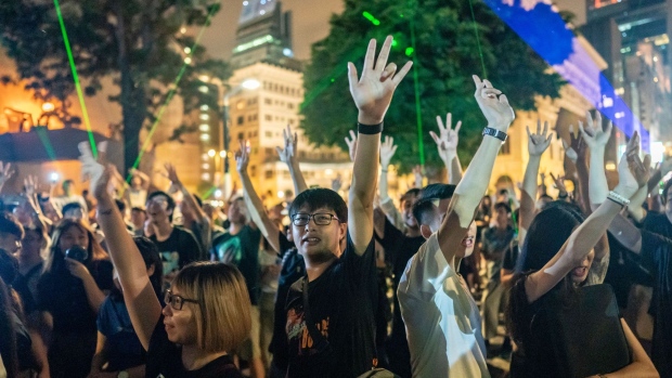 HONG KONG, CHINA - AUGUST 8: Protesters point lazer beams at the Hong Kong Space Museum and make gesture during a demonstration on August 8, 2019 in Hong Kong, China. Pro-democracy protesters have continued rallies on the streets of Hong Kong against a controversial extradition bill since 9 June as the city plunged into crisis after waves of demonstrations and several violent clashes. Hong Kong's Chief Executive Carrie Lam apologized for introducing the bill and declared it "dead", however protesters have continued to draw large crowds with demands for Lam's resignation and completely withdraw the bill. (Photo by Anthony Kwan/Getty Images)
