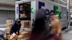 A driver for an independent contractor to FedEx Corp. unloads packages from a delivery truck in New York, U.S., on Monday, Nov. 26, 2018. Americans spent $50.6 billion online this month through Sunday, a 20 percent increase from a year ago and spearheaded by a 24 percent surge to $6.2 billion on Black Friday, according to Adobe Analytics. Cyber Monday is expected to add another $7.8 billion -- an 18 percent year-over-year gain for that day. 