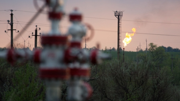 A flare stack burns beyond oil control valves in an oil field near Samara, Russia, on Tuesday, May 14, 2019. The nearby village of Nikolayevka in central Russia has emerged as the epicenter of an international oil scandal with authorities saying corrosive chlorides entered Russia’s 40,000-mile network of oil pipelines, causing the first-ever shutdown of the main export artery to Europe. 