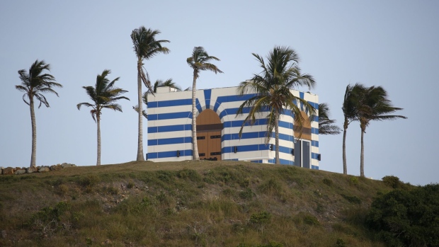 A building stands on top of a hill on Little St. James Island, owned by fund manager Jefferey Epstein, in St. Thomas, U.S. Virgin Islands, on Wednesday, July 10, 2019. This is where Epstein –- convicted of sex crimes a decade ago in Florida and now charged in New York with trafficking girls as young as 14 –- repaired, his escape from the toil of cultivating the rich and powerful. 