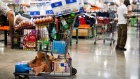 A customer stands by a shopping cart inside a store in Miami 