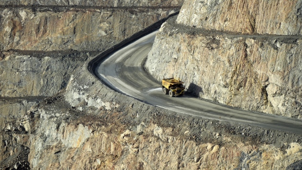 A dump truck travels along an access ramp at an open pit mine. 
