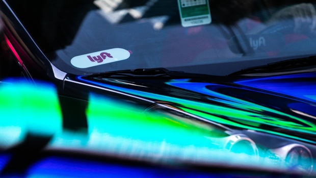 A Lyft Inc. sticker is displayed on a vehicle in the Time Square neighborhood of New York, U.S., on Wednesday, May 8, 2019. Simmering tensions between drivers and ride-hailing companies are flaring again, as drivers in major cities across the U.S. and the U.K. went on strike Wednesday over low wages and unstable working conditions. 