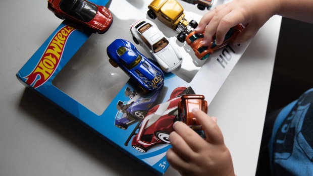A child plays with Mattel Inc. Hot Wheels brand matchbox cars in Atlanta, Georgia, U.S., on Saturday, July 20, 2019. Mattel is scheduled to release earnings figures on July 25. 