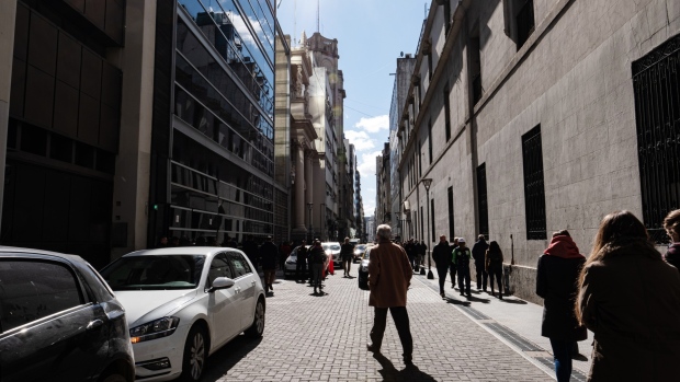 Pedestrians walk in a street of the financial district in Buenos Aires. 