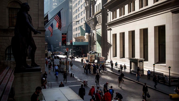 Pedestrians walk near the New York Stock Exchange. 