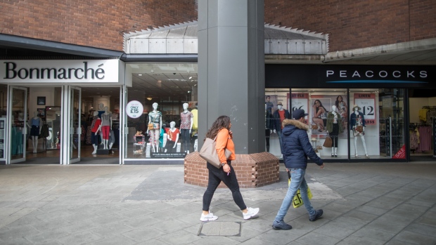 Pedestrians pass a Bonmarche Holdings Plc store and a Peacocks Stores Ltd. store in Basildon, U.K., on Friday, April 5, 2019. Billionaire Mike Ashley and Retail tycoon Philip Day are among the few investors willing to brave the carnage in U.K. brick-and-mortar retailers, who have been hurt by the growing clout of online merchants and consumer sentiment that has been depressed by the endless Brexit saga. Photographer: Chris Ratcliffe/Bloomberg