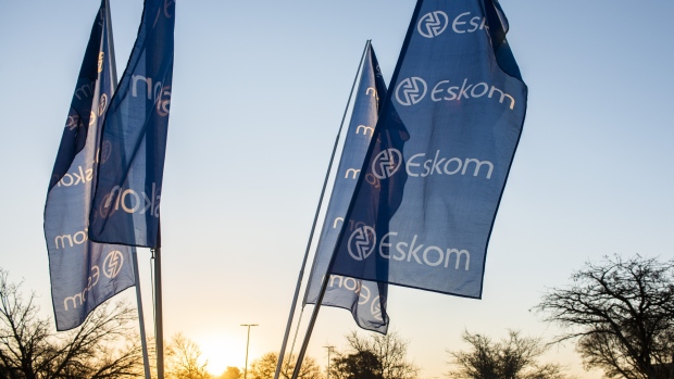 Company flags fly outside the Eskom Holdings SOC Ltd. Megawatt Park headquarters office in Johannesburg, South Africa, on Tuesday, July 30, 2019. Eskom reported a record loss of 20.7 billion rand. 