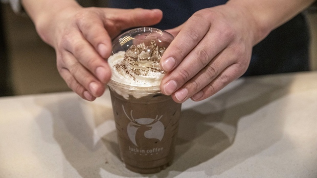 An employee prepares an iced coffee beverage in a Luckin Coffee outlet in Beijing, China, on Tuesday, Jan. 15, 2019. Luckin, the Chinese startup that's banking on selling cappuccinos to on-the-go office workers, is spending millions of dollars a year opening outlets to unseat Starbucks Corp. as the top java seller in the country. 