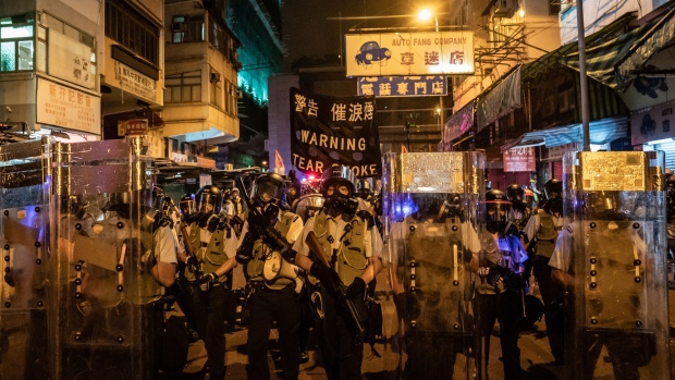 Police try to disperse protesters in Sham Shui Po on Aug. 14. Photographer: Anthony Kwan/Getty Images