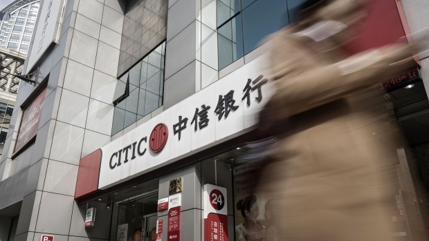 A pedestrian walks past a China Citic Bank Corp. branch in Shanghai, China, on Tuesday, March 21, 2017. China Citic is scheduled to release full-year earnings results on March 22. 