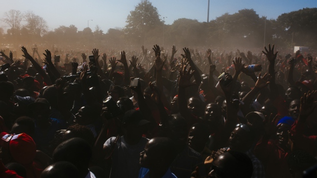 Supporters raise their hands during a Movement for Democratic Change (MDC) campaign rally in Harare, Zimbabwe, on Saturday, July 28, 2018. Zimbabwe's political parties made a last-ditch pitch for votes on Saturday ahead of July 30 elections as a campaign distinguished by the absence of widespread violence that marred previous contests drew to a close. 