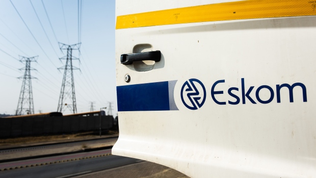 A company logo is displayed on a sign outside the Eskom Holdings SOC Ltd. Grootvlei coal-fired power station in Mpumalanga, South Africa, on Wednesday, Aug. 7, 2019. Eskom, South Africa’s biggest polluter, said emissions of particulate matter that cause chronic respiratory disease are at their highest level in two decades as the state power utility’s financial meltdown has seen it skip maintenance and has triggered strikes. 