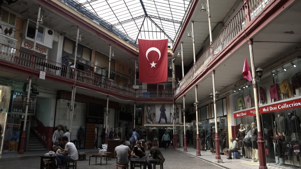 Pedestrians sit in the atrium of a leather clothes market in Istanbul. 