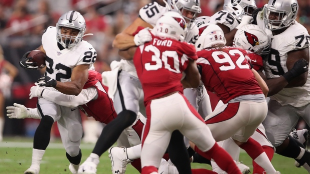 GLENDALE, ARIZONA - AUGUST 15: Running back Doug Martin #22 of the Oakland Raiders rushes the football against the Arizona Cardinals during the first half of the NFL preseason game at State Farm Stadium on August 15, 2019 in Glendale, Arizona. (Photo by Christian Petersen/Getty Images)