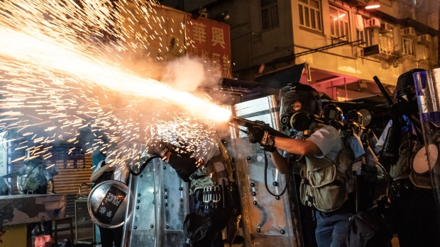 HONG KONG, CHINA - AUGUST 3: A protester throws a molotov cocktail on the ground during a stand-off with police on August 3, 2019 in Hong Kong, China. Pro-democracy protesters have continued rallies on the streets of Hong Kong against a controversial extradition bill since 9 June as the city plunged into crisis after waves of demonstrations and several violent clashes. Hong Kong's Chief Executive Carrie Lam apologized for introducing the bill and declared it "dead", however protesters have continued to draw large crowds with demands for Lam's resignation and completely withdraw the bill. (Photo by Anthony Kwan/Getty Images) 