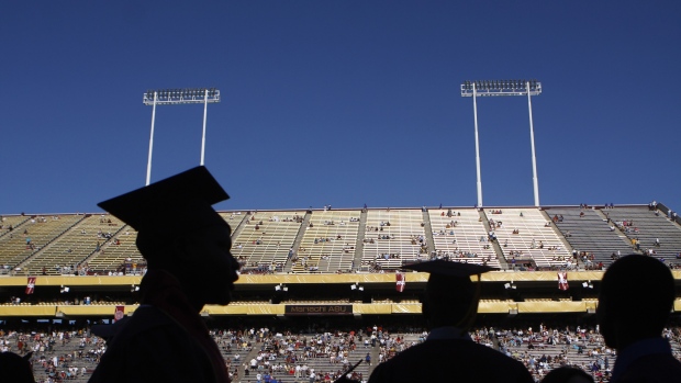 TEMPE, AZ - MAY 13: PHOENIX, AZ - MAY 13: Arizona State University graduate students are silhouetted during their graduation at Sun Devil Stadium May 13, 2009, in Tempe, Arizona. US President Barack Obama will deliver the commencement address during the ceremony where over 65,000 people are expected to attended. (Photo by Joshua Lott/Getty Images)