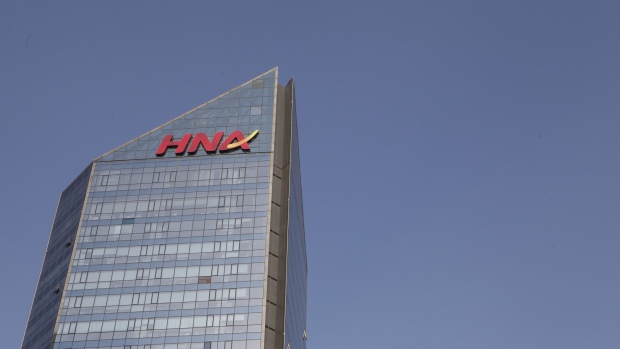 Signage for HNA Group Co. is displayed atop the company's building in Beijing, China, on Thursday, Feb. 1, 2018. Companies linked to HNA have secured 7.8 billion yuan ($1.2 billion) in long-term loans from Chinese banks to finance an expansion project in Meilan Airport in HNA's home province of Hainan. 