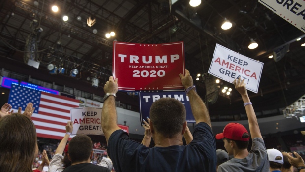 Attendees attend a Trump rally in Cincinnati.  Photographer: Matthew Hatcher/Bloomberg
