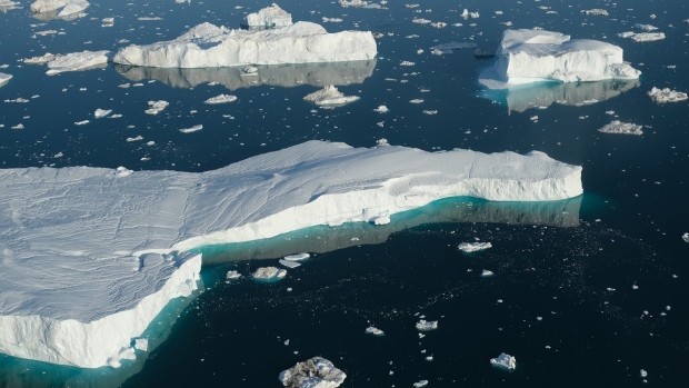 ILULISSAT, GREENLAND - AUGUST 04: In this view from an airplane icebergs float at the mouth of the Ilulissat Icefjord on August 04, 2019 near Ilulissat, Greenland. The Sahara heat wave that recently sent temperatures to record levels in parts of Europe has also reached Greenland. Climate change is having a profound effect in Greenland, where over the last several decades summers have become longer and the rate that glaciers and the Greenland ice cap are retreating has accelerated. (Photo by Sean Gallup/Getty Images) 