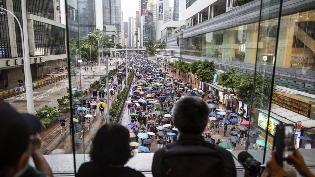 Demonstrators march during a protest in Hong Kong, on Aug. 18. Photographer: Justin Chin/Bloomberg