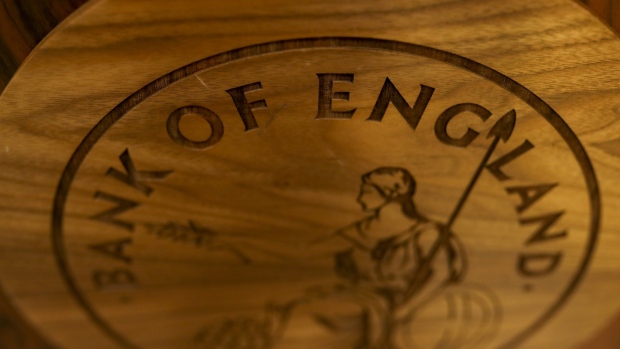 A wooden plaque of the Bank of England (BOE) logo sits on a desk ahead of the bank's quarterly inflation report news conference in the City of London, U.K., on Thursday, Aug. 1, 2019. BOE Governor Mark Carney will confront the new realities of Brexit and the increasing likelihood of a no-deal departure from the European Union in the central bank’s interest-rate decision on Thursday. 