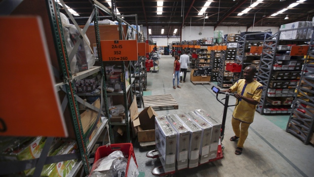 A worker pushes a pallet truck of stock inside a Jumia Technologies AG distribution warehouse in Lagos, Nigeria. 