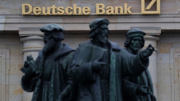 The Gutenberg memorial statue stands outside a Deutsche Bank AG bank branch in Frankfurt, Germany. 
