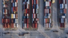 Trucks move past containers stacked at the Yangshan Deepwater Port, operated by Shanghai International Port Group Co. (SIPG), in this aerial photograph taken in Shanghai, China, on Wednesday, Aug. 7, 2019. Trump's threat to raise tariffs on all Chinese goods last week shattered a truce reached with Xi just weeks earlier, unleashing tit-for-tat actions on trade and currency policy that risk accelerating a wider geopolitical fight between the world's biggest economies. 