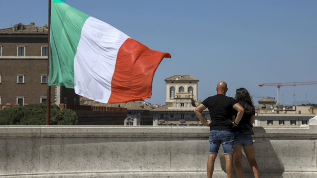 The Italian national flag flies near a monument to the unknown soldier in Rome, Italy, on Wednesday, Aug. 21, 2019. Italian President Sergio Mattarella begins intensive talks with political leaders Wednesday to determine whether a new ruling coalition is viable, as the head of one of the country’s main parties signaled willingness to explore a new parliamentary majority. 