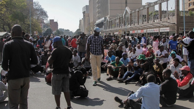 HARARE, ZIMBABWE - AUGUST 16: Demonstrators sit and sing protest songs after police cordoned off the street on August 16, 2019 in Harare, Zimbabwe. The country's main opposition party, Movement for Democratic Change, called for protests against President Emmerson Mnangagwa and his government's management of the economy. Nearly two years after Mnangagwa took power, the country faces rising inflation, increased poverty, and a severe water shortage. (Photo by Tafadzwa Ufumeli/Getty Images)
