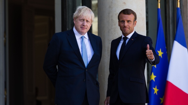 Boris Johnson, U.K. prime minister, left, and Emmanuel Macron, France's president, pose for photographer after delivering statements in the courtyard of Elysee Palace in Paris, France, on Thursday, Aug. 22, 2019. Macron gave Johnson little hope he’s prepared to compromise on Brexit and said any changes to the current deal won’t be very significant. Photographer: Jeanne Frank/Bloomberg