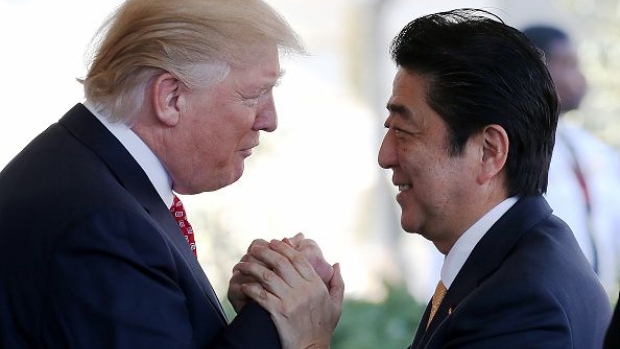 President Donald Trump greets Japanese Prime Minister Shinzo Abe as he arrives at the White House on February 10, 2017 in Washington, DC. 