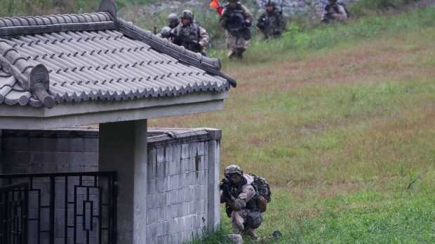 A U.S. army soldier aims his weapon and takes position behind a wall during Warrior Strike VIII, a bilateral training exercise between the U.S. Army's 2nd Armored Brigade Combat Team, 1st Cavalry Division, and the the South Korean army in Paju, South Korea, on Tuesday, Sept. 19, 2017. North Korea has fired two missiles over Japan in the past month, both of which landed in the Pacific Ocean beyond the northern island of Hokkaido. Leader Kim Jong Un has threatened to fire missiles into waters near Guam, home to U.S. military bases in the Pacific. 