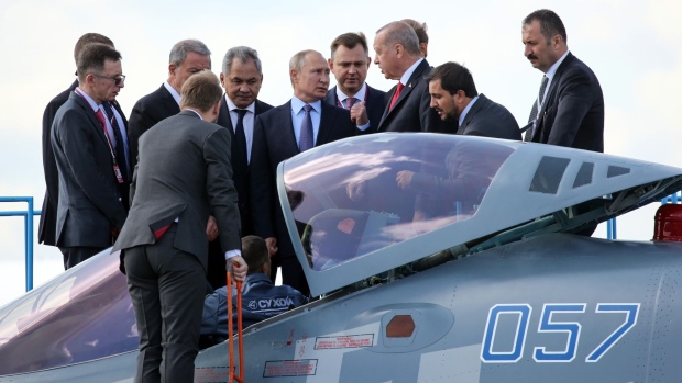 Vladimir Putin and Recep Tayyip Erdogan inspect a Sukhoi Su-57 fighter jet in Moscow, on Aug. 27. oPhotographer: Andrey Rudakov/Bloomberg