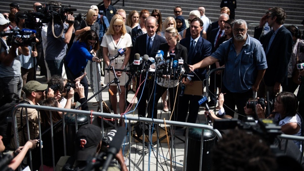 Chauntae Davies, an alleged victim of Jeffrey Epstein, center, speaks outside federal court in New York on Aug. 27. Photographer: Mark Kauzlarich/Bloomberg