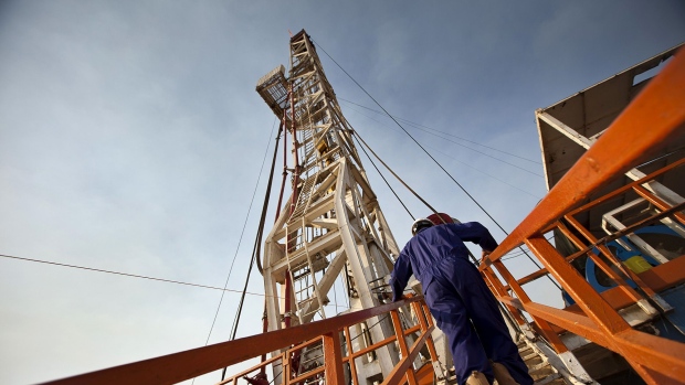 A worker for the Chinese company Zhongyuan Petroleum Exploration Bureau (ZPEB) climbs onto the drilling platform of an oilrig near Melut, in the Upper Nile, Sudan, on Monday, Nov. 29, 2010. 
