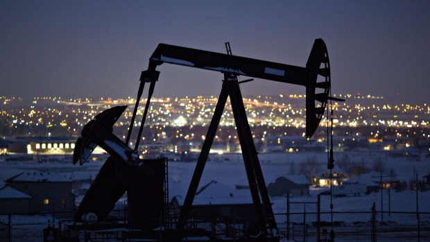 A pumpjack operates above an oil well at night in the Bakken Formation on the outskirts of Williston, North Dakota, U.S., on Thursday, March 8, 2018. When oil sold for $100 a barrel, many oil towns dotting the nation's shale basins grew faster than its infrastructure and services could handle. Since 2015, as oil prices floundered, Williston has added new roads, including a truck route around the city, two new fire stations, expanded the landfill, opened a new waste water treatment plant and started work on an airport relocation and expansion project. 