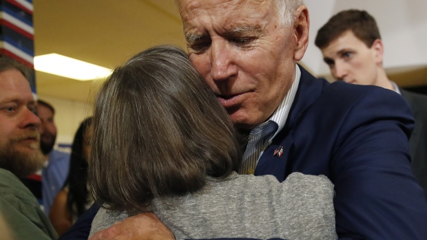 Former U.S. Vice President Joe Biden, 2020 Democratic presidential candidate, hugs an attendee during a campaign event in Davenport, Iowa, U.S., on Tuesday, June 11, 2019.  