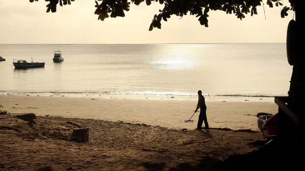 A worker prepares the beach near a private resort hotel on January 10, 2008 in Mombasa, Kenya. Tourism is a $1 billion industry in Kenya.  
