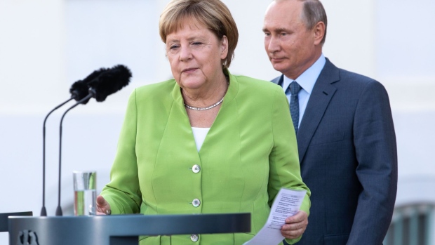 GRANSEE, GERMANY - AUGUST 18: German Chancellor Angela Merkel and Russian President Vladimir Putin arrive to deliver a joint press statement prior to their meeting at Schloss Meseberg palace, the German government retreat, at Meseberg on August 18, 2018 in Gransee, Germany. The two leaders are meeting to discuss a variety of issues, including the current international sanctions imposed on Russia, the situation in Syria as well as the situation in eastern Ukraine. (Photo by Omer Messinger/Getty Images)