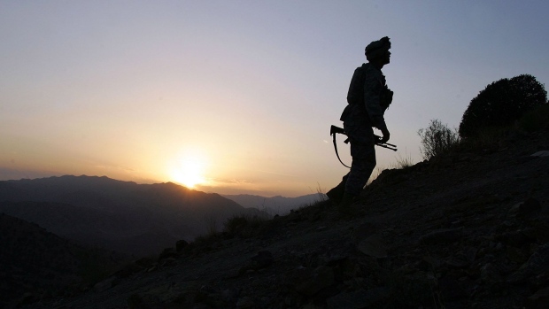 A U.S. Army soldier climbs a hill towards an American outpost October 15, 2006 near Camp Tillman, Afghanistan just two kilometers from the Pakistan border.