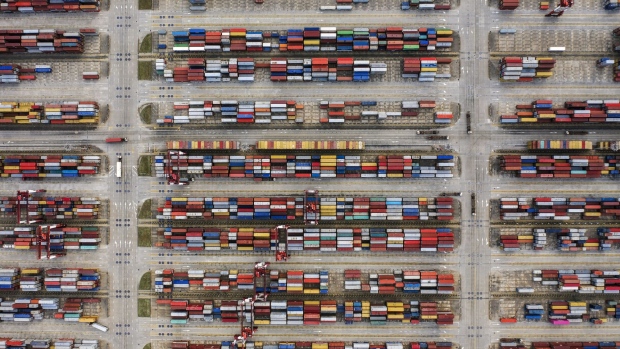 Shipping containers sit stacked at the Yangshan Deepwater Port, operated by Shanghai International Port Group Co. (SIPG), in this aerial photograph taken in Shanghai, China, on Friday, May 10, 2019. The U.S. hiked tariffs on more than $200 billion in goods from China on Friday in the most dramatic step yet of President Donald Trump's push to extract trade concessions, deepening a conflict that has roiled financial markets and cast a shadow over the global economy. 