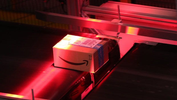 A red light scans a parcel on a conveyor belt inside an Amazon.com Inc. fulfilment center at an Amazon.com Inc. fulfilment center during the online retailer's Prime Day sales promotion day in Koblenz, Germany, on Monday, July 15, 2019. Amazon is tapping high-profile actors, athletes and social-media sensations like never before to maintain buzz around its Prime Day summer sale, now in its fifth year and battling increasing competition from rivals. 