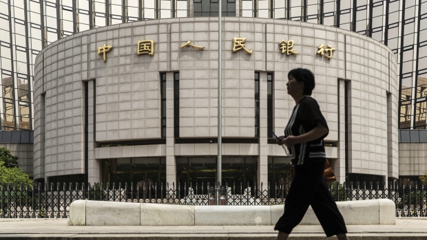 A pedestrian walks past the People's Bank of China (PBOC) headquarters in Beijing, China, on Friday, June 7, 2019. China's central bank governor said there's "tremendous" room to adjust monetary policy if the trade war deepens, joining counterparts in Europe and the U.S. in displaying readiness to act to support the economy. 