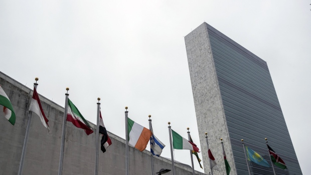 United Nations (UN) and American flags fly outside UN headquarters in New York, U.S., on Friday, April, 27, 2018. Donald Trump seems set on pulling out of the Iran nuclear deal next week, with U.S. officials suggesting that any initial diplomatic turbulence will be followed by negotiations for a new accord. 